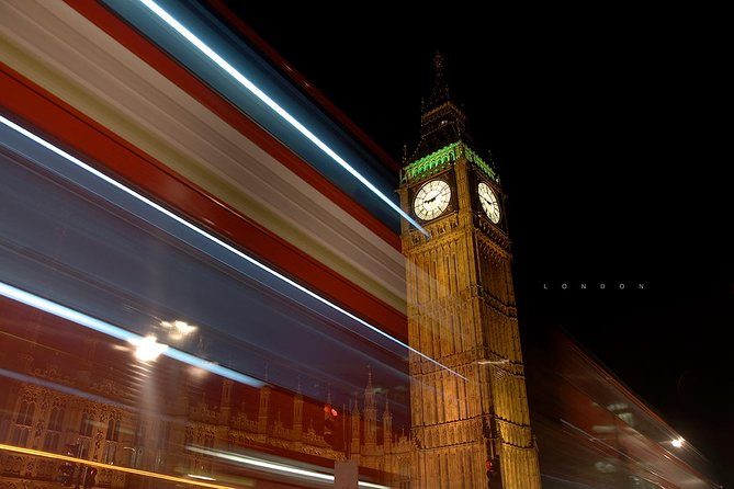 The Elizabeth Tower at night with the light trails of a passing bus streaked across the frame