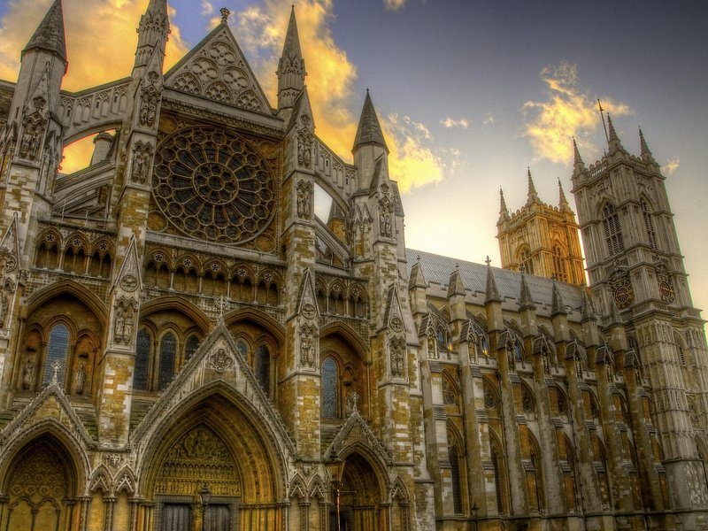 The west front of Westminster Abbey with its twin towers against a bright sky